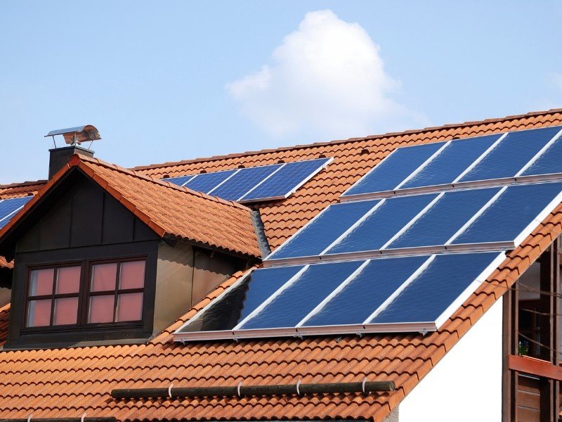 A house is showing whose rooftop has a solar panel system.