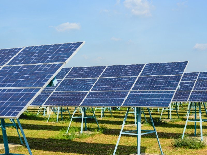 A farm showing multiple solar panel systems installed at a large level.