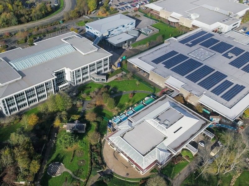 An industrial area is shown using solar panels to power their factories.